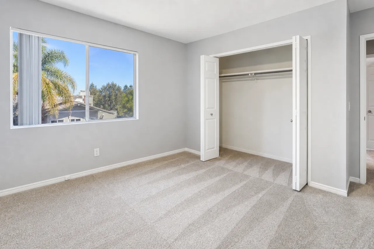 Compact apartment bedroom with freshly cleaned carpet